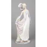 A Lladro ceramic figure; Socialite of the 20's, 5283. 34cm tall.
