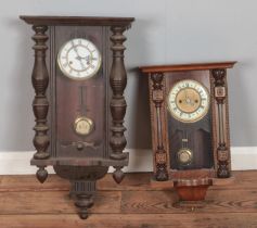 Two mahogany case wall clocks with brass pendulums with pot inset marked R-A. both clocks missing