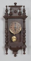 A mahogany wall clock with enamel face, turned columns and finials. Hx56cm