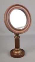 An early 20th century mahogany shaving mirror with brass fluted pedestal base.