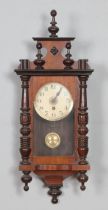 A mahogany wall clock with enamel face, turned columns and finials. Hx71cm