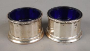 A pair of William Neale & Son Ltd silver salts with Bristol blue liners. Dated 1938 and 1939.