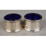 A pair of William Neale & Son Ltd silver salts with Bristol blue liners. Dated 1938 and 1939.