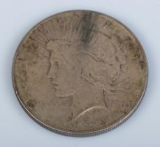 A 1922 silver Peace Dollar. 26.6g.