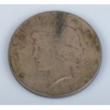 A 1922 silver Peace Dollar. 26.6g.