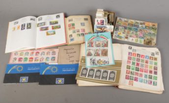 A collection of international postage stamps and cigarette cards to include British, Chinese,