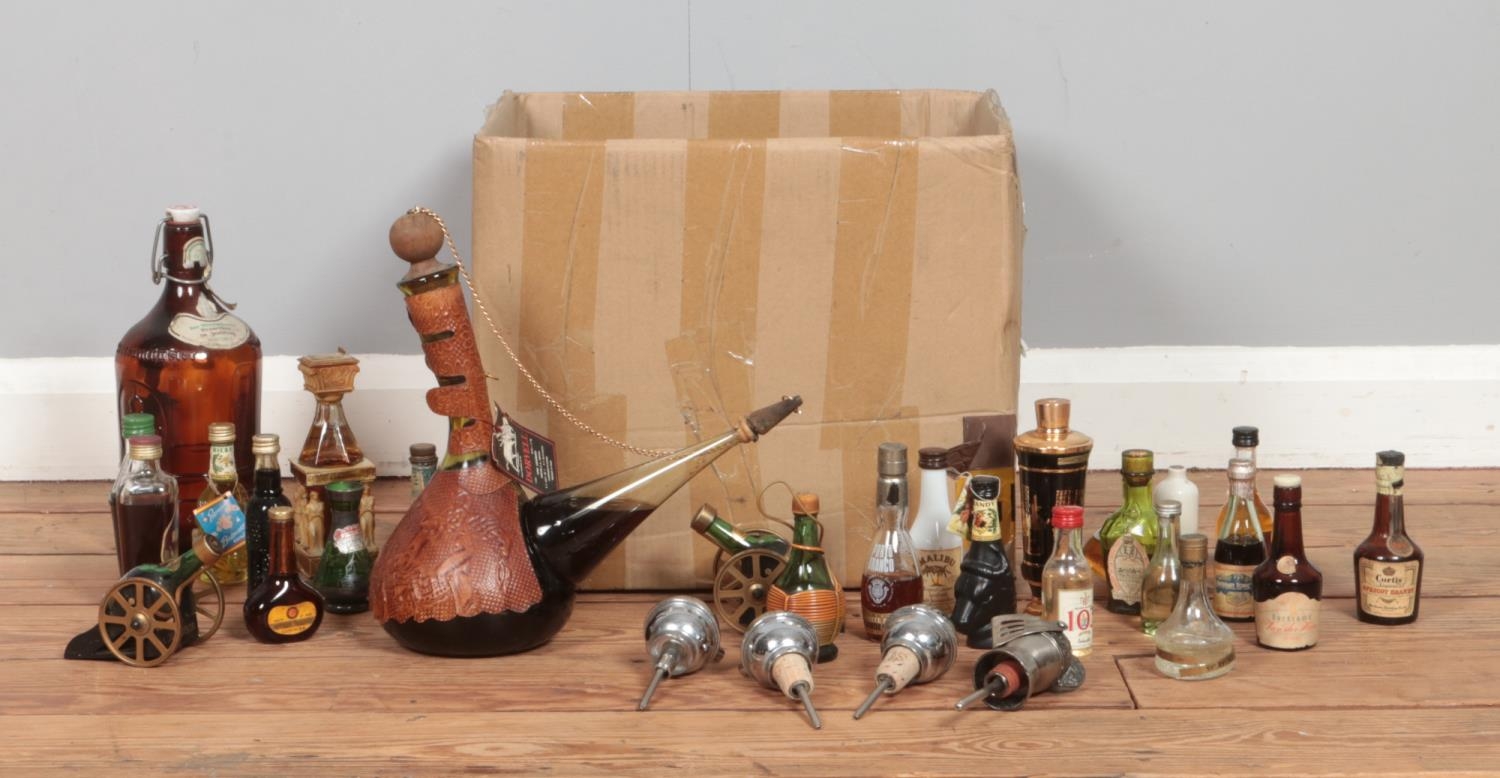 A box of alcohol and alcohol miniatures, to include Malibu, Dorvell wine, Courvoisier and novelty