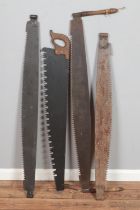 A collection of vintage saws mostly two man examples.