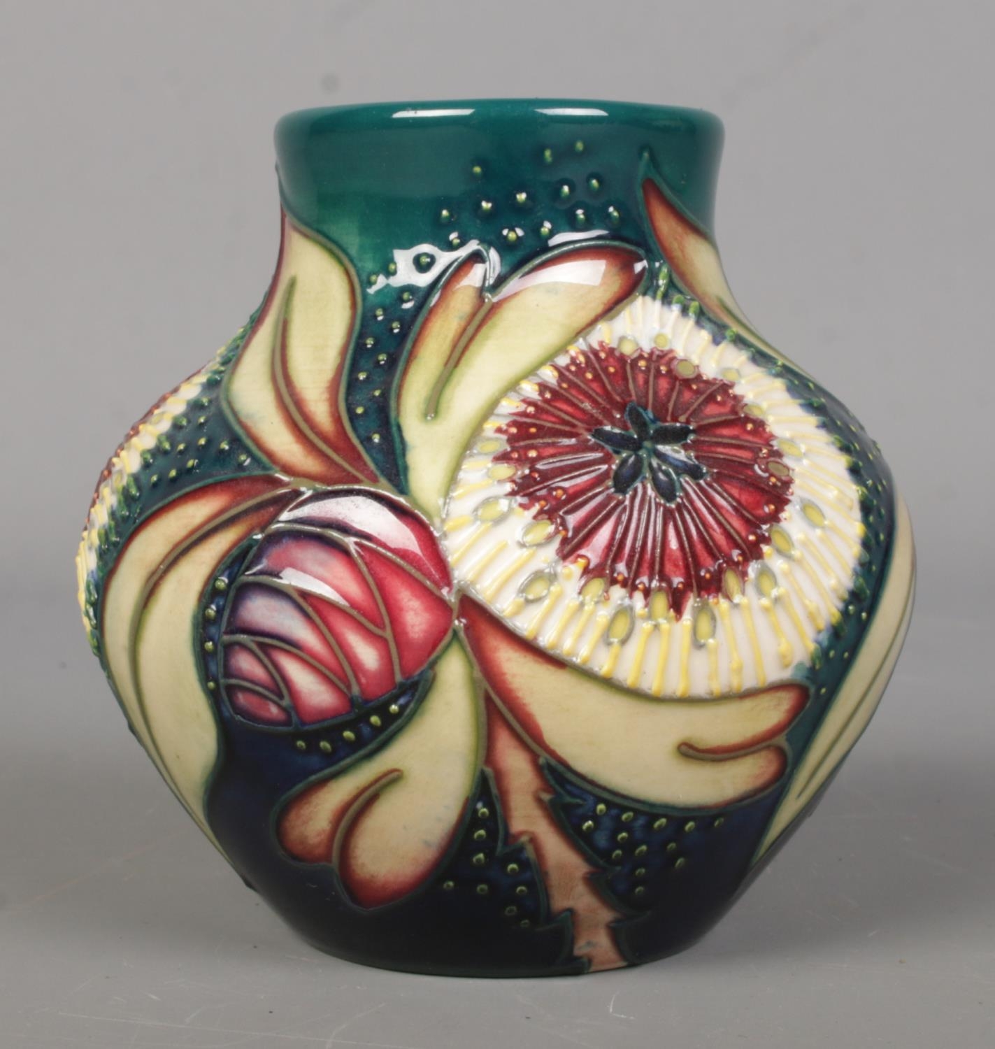 A Moorcroft pottery vase of ovoid form, in the 'Albany' pattern. 8.5cm tall. Bares leaf mark to