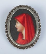 A silver brooch featuring hand painted portrait of a maiden. Stamped 800 to reverse.