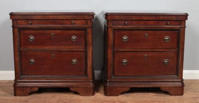 A pair of Vietnamese made nightstands, with two drawers below a pull out tray. Both have '