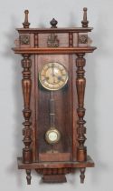 A Victorian mahogany wall clock with turned and carved design. Hx83cm