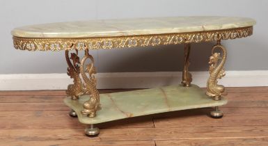 A brass and onyx two tier coffee table, with dolphin supports. Height: 45cm, Width: 117cm, Depth: