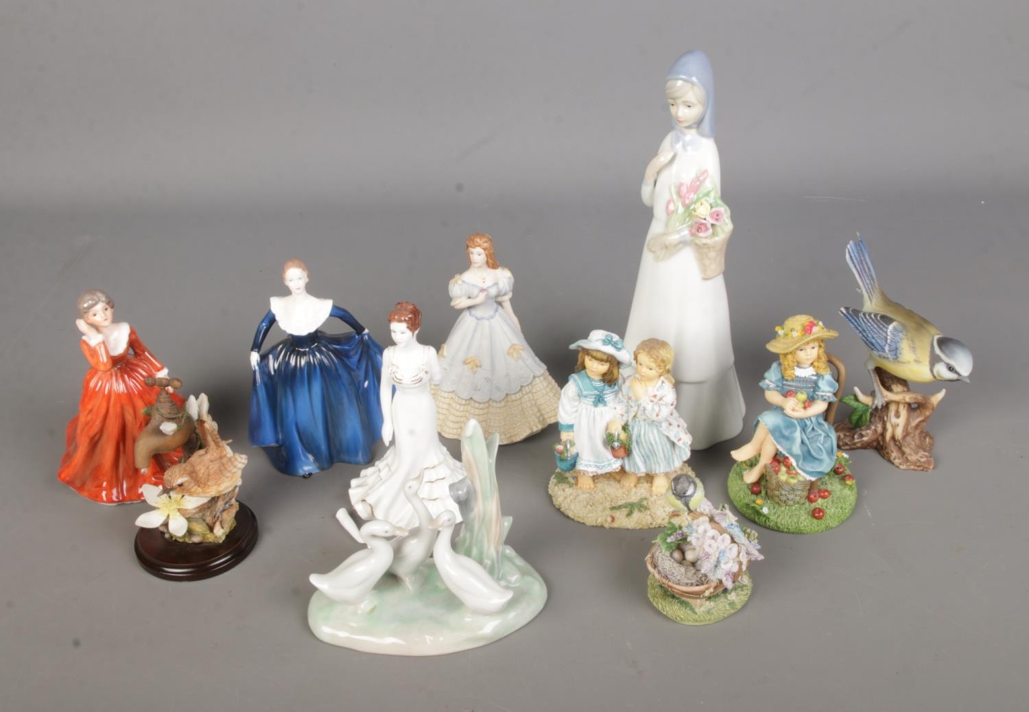 A collection of assorted figures to include Nao by Lladro duck family, Coalport ladies, Country