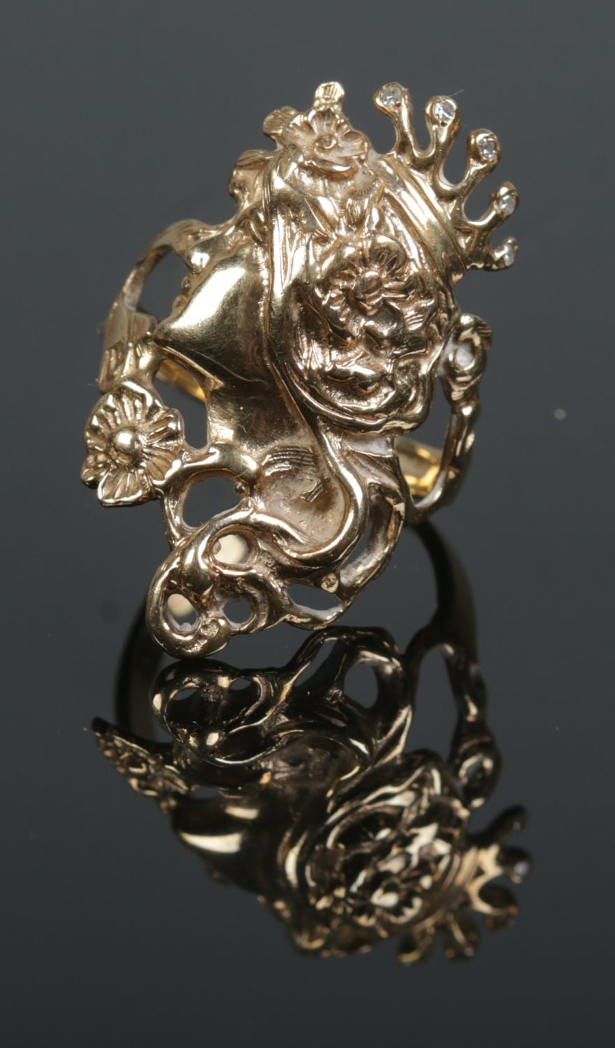 A 9ct gold art nouveau style ring formed as the profile of maiden wearing crown set with diamond.