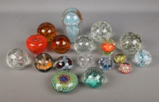 A good collection of glass paperweights to include large jellyfish, floral, apple and millefiori