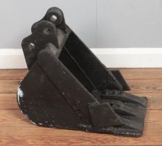 A cast iron mini digger bucket. Standing height 45cm approx