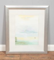 A framed watercolour landscape depicting seaside landscape featuring sailboat and children playing
