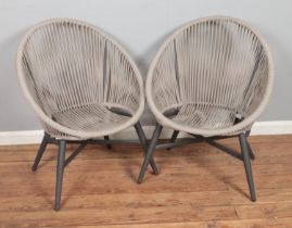 A pair of garden tub chairs featuring rope work back and seat.