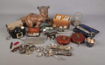 A box of assorted collectables to include carved figure of a baby, silver plate, John Rabone tape