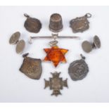 A collection of silver oddments, to include riding crop badge depicting a fox head, fobs,
