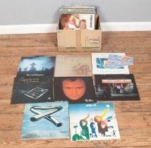 A box of assorted vinyl records and single of mainly pop and rock to include Black Sabbath, Phil