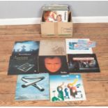 A box of assorted vinyl records and single of mainly pop and rock to include Black Sabbath, Phil