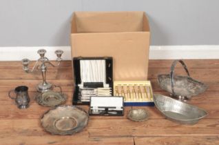 A box of assorted metalwares, to include three branch candelabra, swing handled basket, lidded
