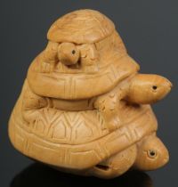 A hand carved hardwood netsuke of a trio of turtles.