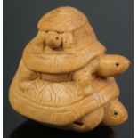 A hand carved hardwood netsuke of a trio of turtles.