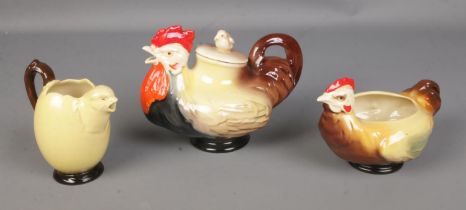A Royal Doulton chicken family tea service featuring rooster pot, chicken sugar bowl and chick/egg