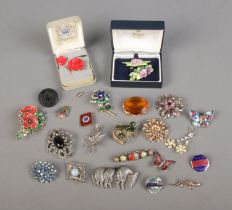A collection of vintage brooches to include floral, butterfly and Jet examples.