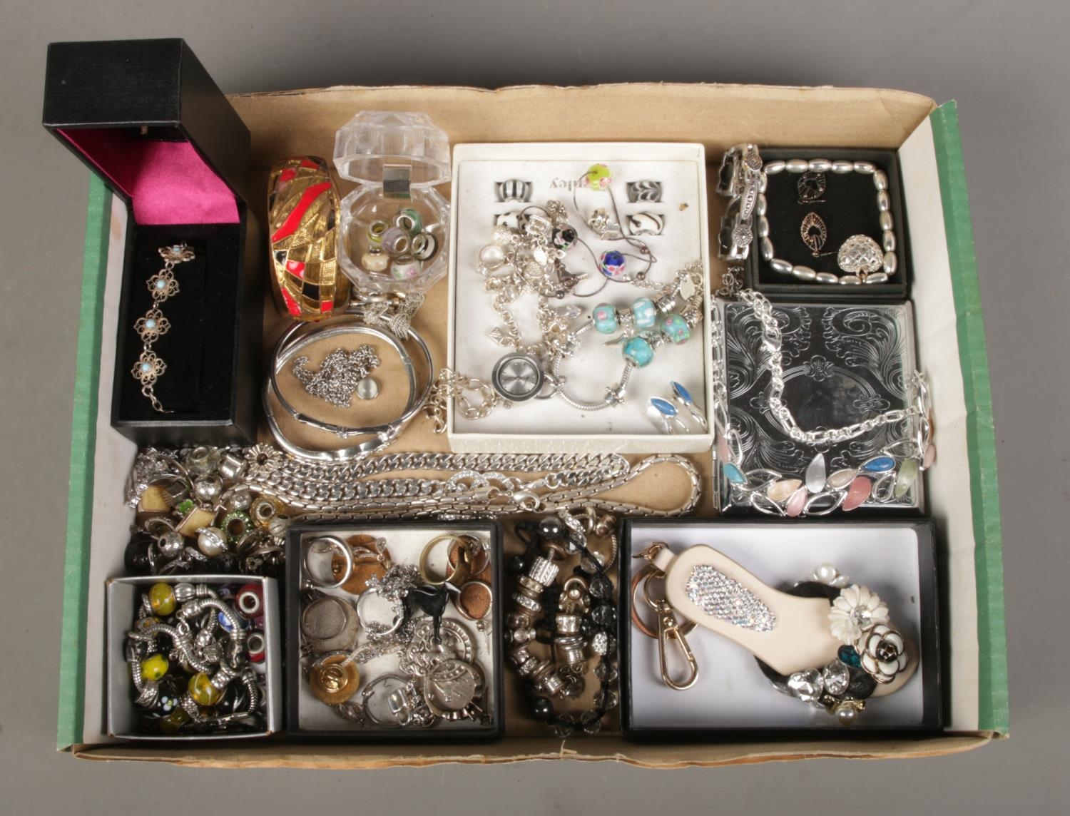 A tray of assorted costume jewellery, to include Pandora style bracelet and charms, hinged bangle,