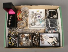 A tray of assorted costume jewellery, to include Pandora style bracelet and charms, hinged bangle,