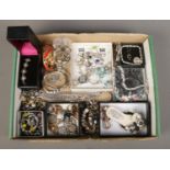 A tray of assorted costume jewellery, to include Pandora style bracelet and charms, hinged bangle,