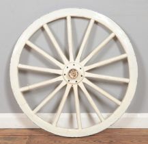 A white painted wooden cartwheel with fourteen spoke design. Diameter: 77cm.