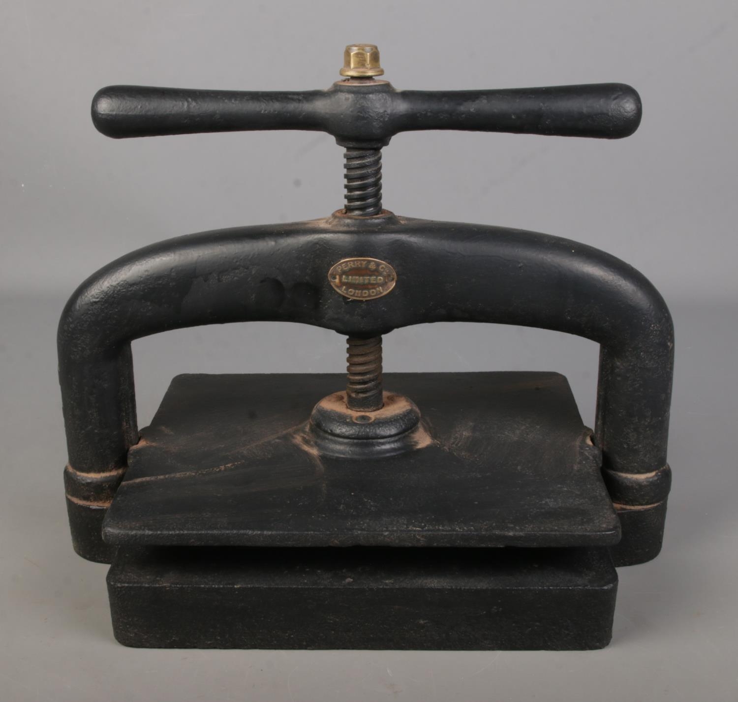 A cast iron hand crank book press by Perry & Co London.