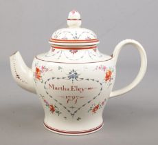 A late 18th century porcelain teapot. Hand painted with flowers and inscribed Martha Eley, 1797.