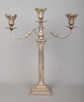 A large George V silver twin branch candelabra with Corinthian column and stepped base. Assayed