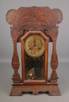 Late 19th century American gingerbread mantle clock, the dial marked ' made in the New Haven Clock