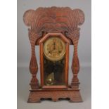 Late 19th century American gingerbread mantle clock, the dial marked ' made in the New Haven Clock