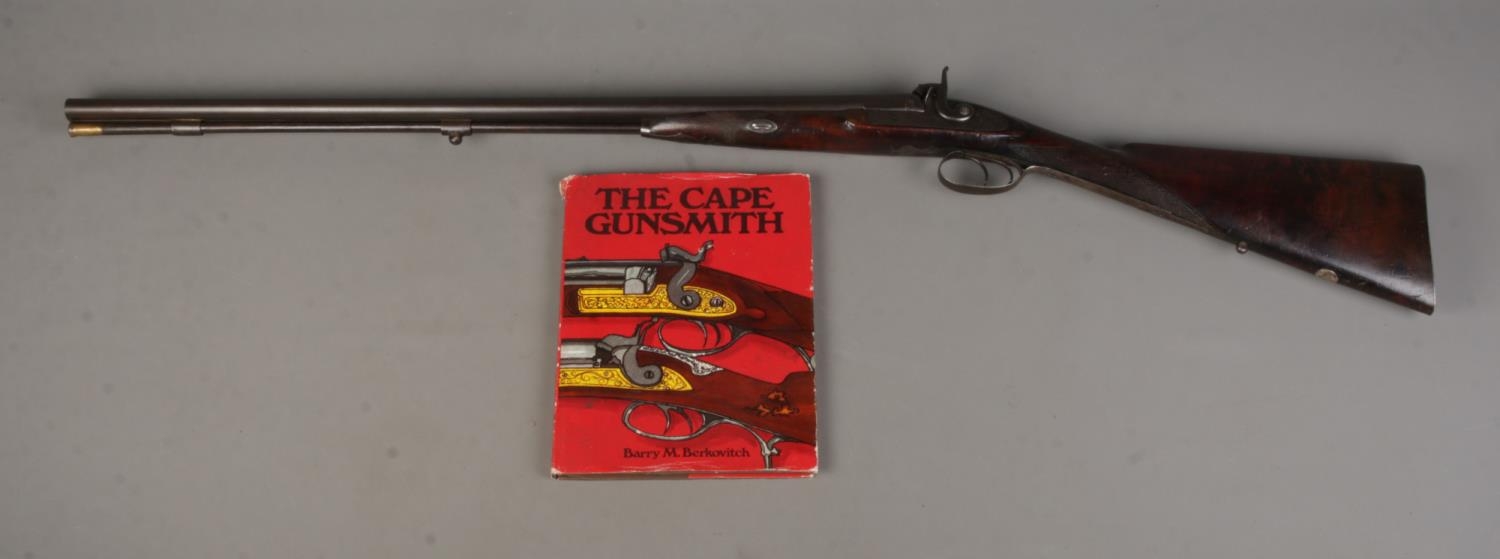 A Charles Pryse & Co double barrelled cape/combination rifle. With damascus barrels and walnut