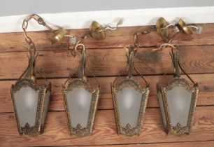 Four hanging lantern lights with frosted glass panels.
