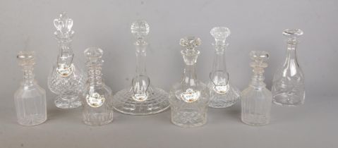 Eight glass decanters, including one Waterford example, together with five ceramic Coalport decanter