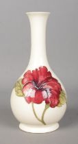 A Moorcroft slender neck vase decorated with hibiscus flower. Crazed.