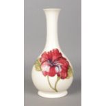 A Moorcroft slender neck vase decorated with hibiscus flower. Crazed.