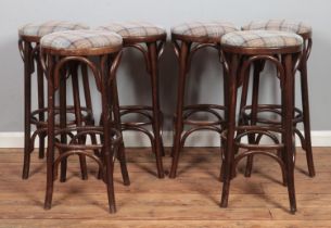 A set of six bentwood bar stools, with chequered pattern fabric seat pads. Height: 78cm.