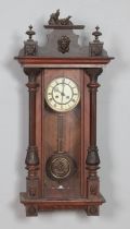 A Victorian mahogany wall clock flanked by turned supports and carved detailing. Hx80cm