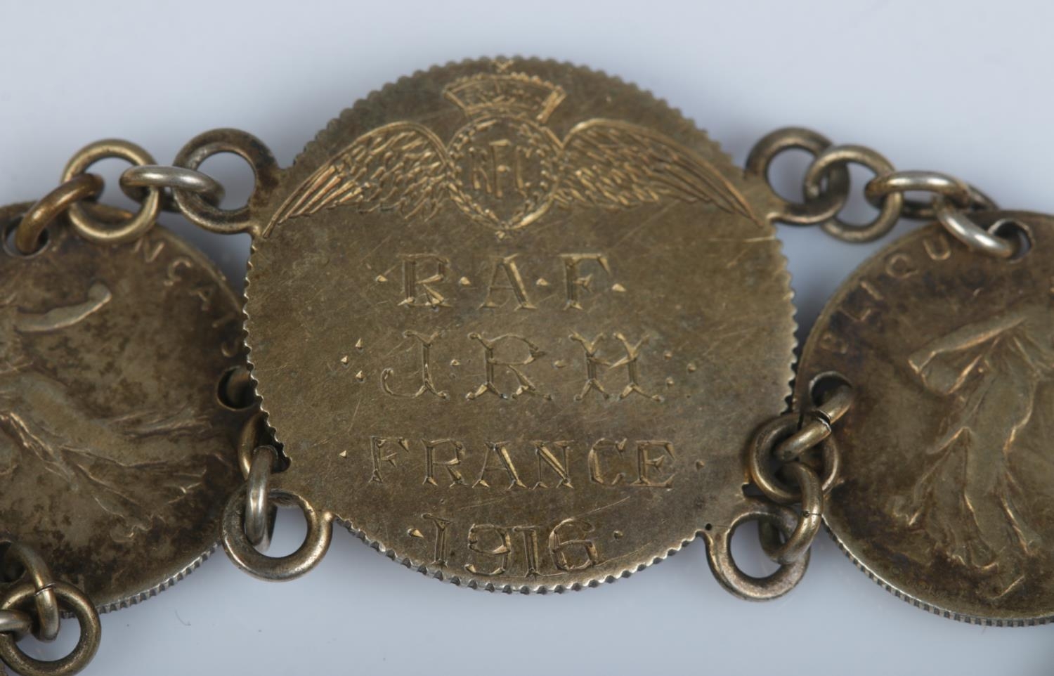 A Royal Flying Corps sweetheart coin bracelet, composed of 1914-17 50 Cenitmes coins and central