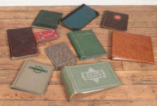 A collection of antique and other empty postcard albums.